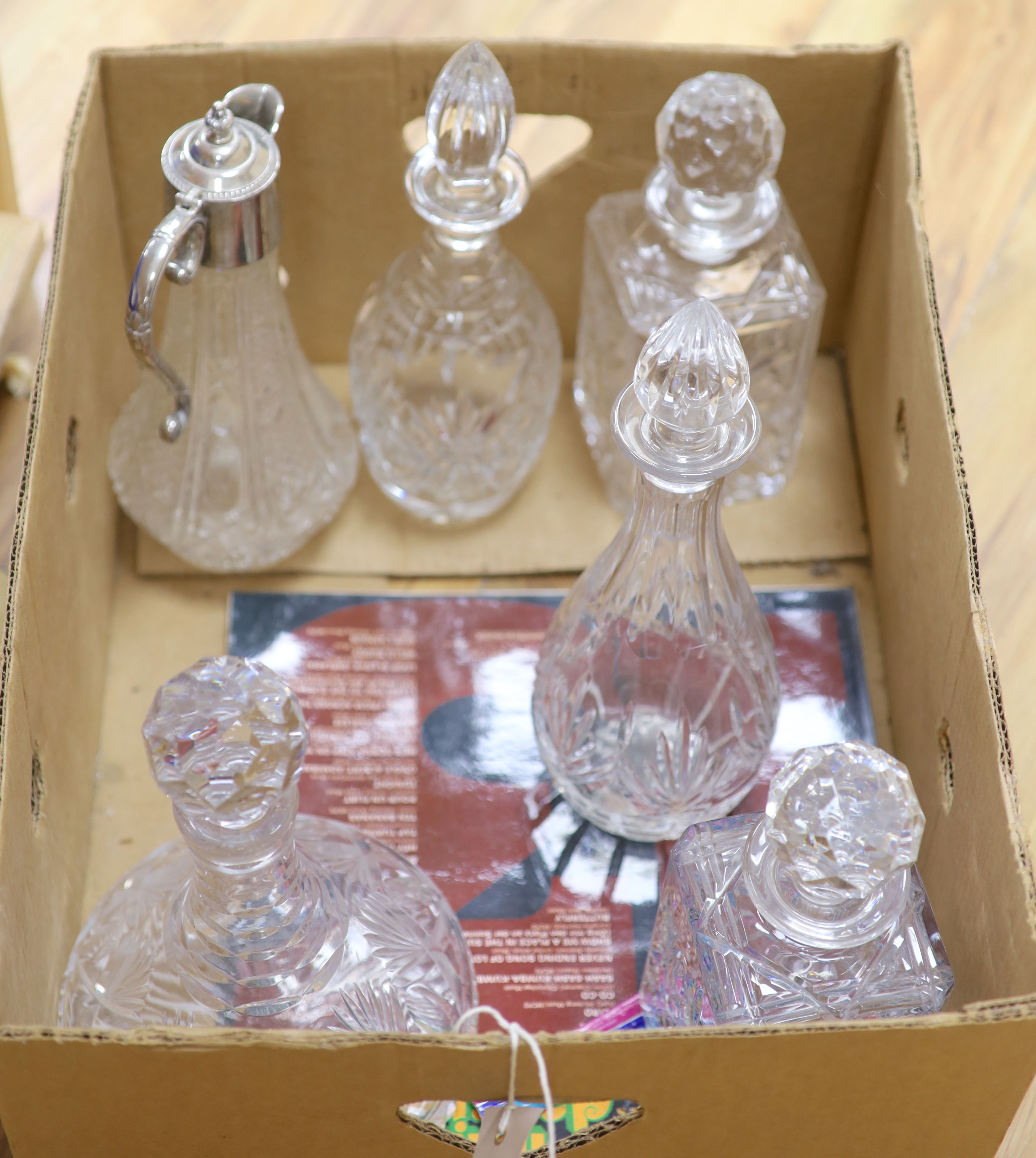 Five various glass decanters and a similar claret jug